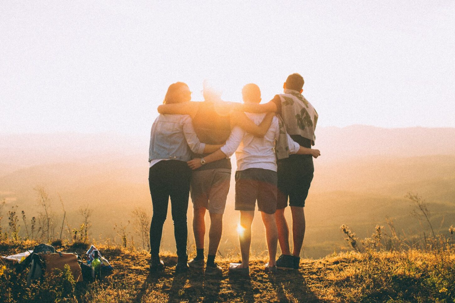 there are four students watching the sunrise and friendship
