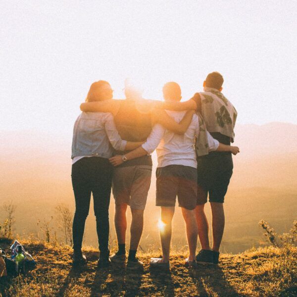 there are four students watching the sunrise and friendship