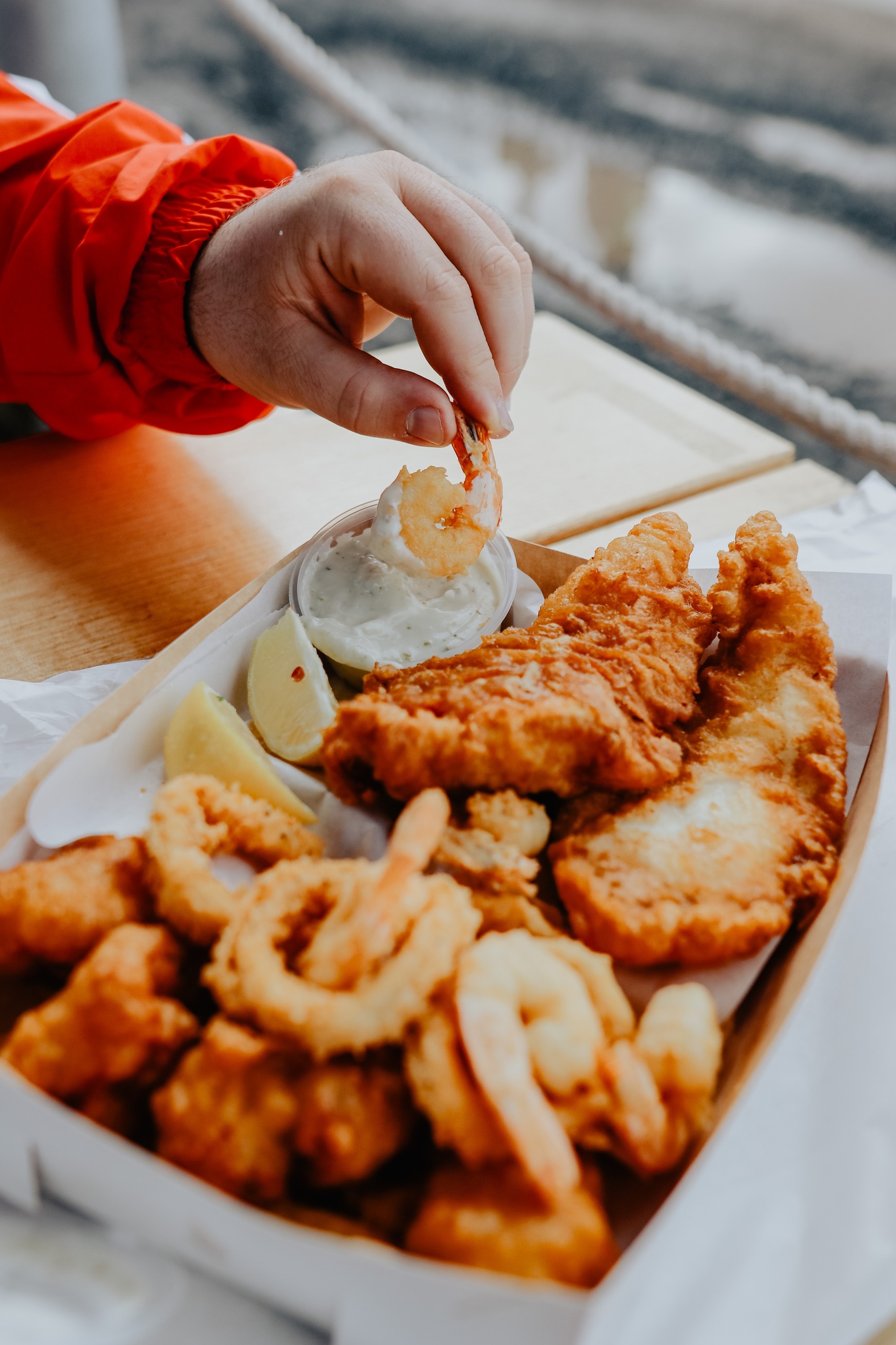 hand dipping fish and chips