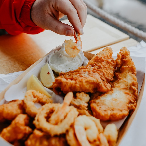 hand dipping fish and chips
