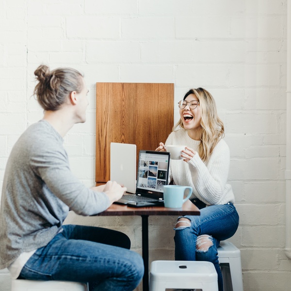 Female students are smiling and talking happily with male students. while studying together