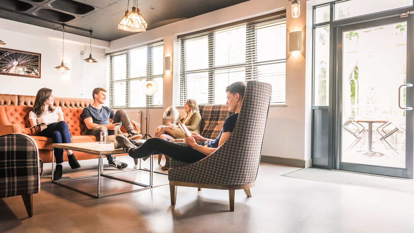 students sit and talk together