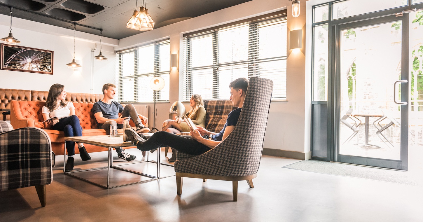 students sit and talk together