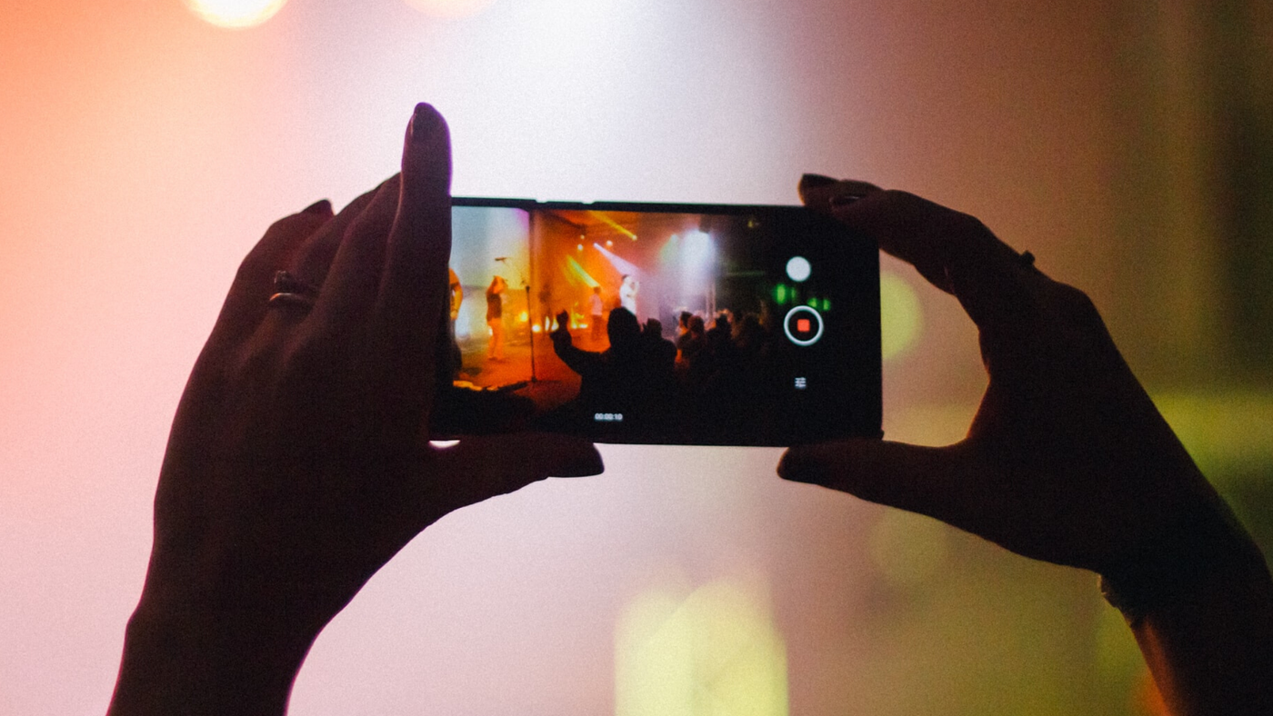 person at concert with phone