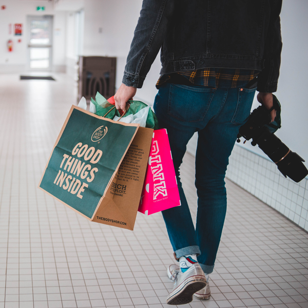 man with shopping bags and camera