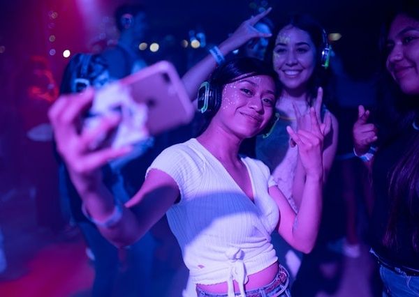 students taking selfie in night club