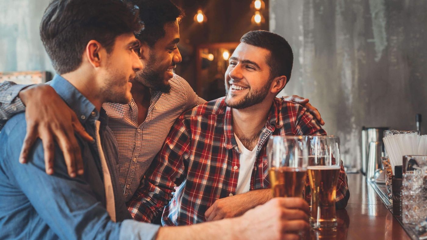 3 friends enjoying a beer in a cosy pub