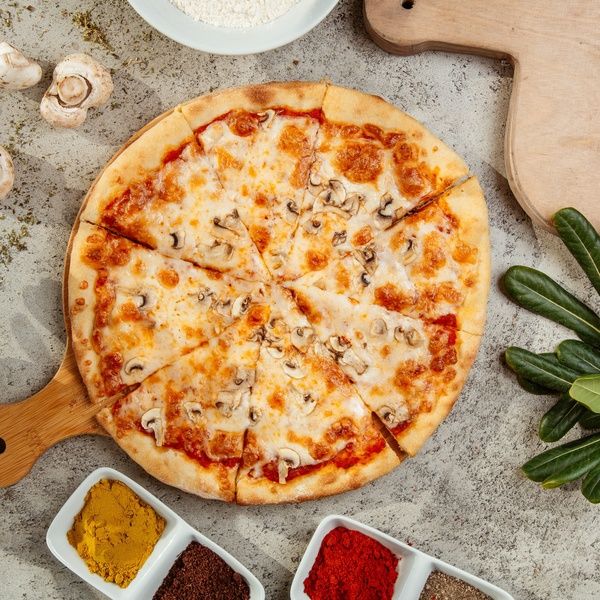 pizza on board with mushrooms