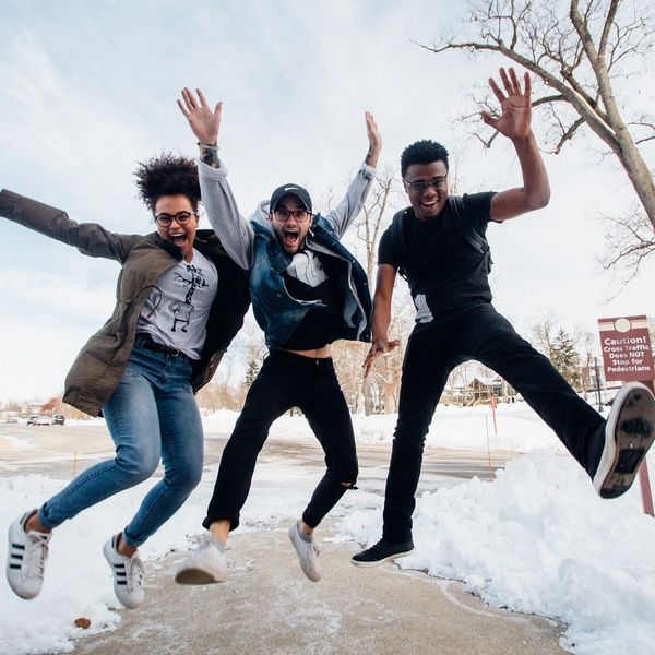 students jumping in snow