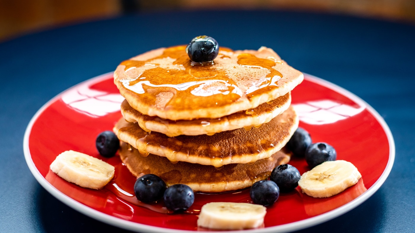 pancakes on red plate with berries