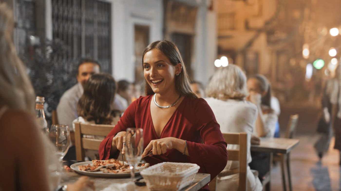 student cutting slice of pizza