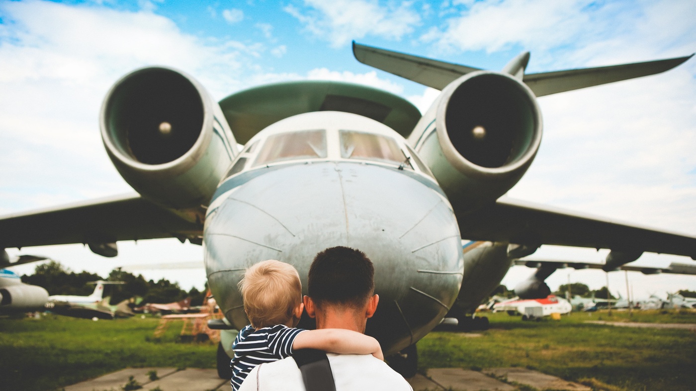 father and son looking at old aeroplane