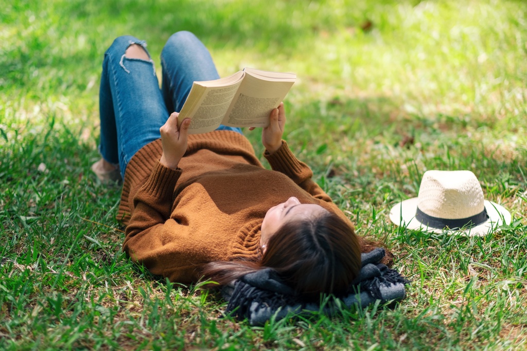 student reading book in park
