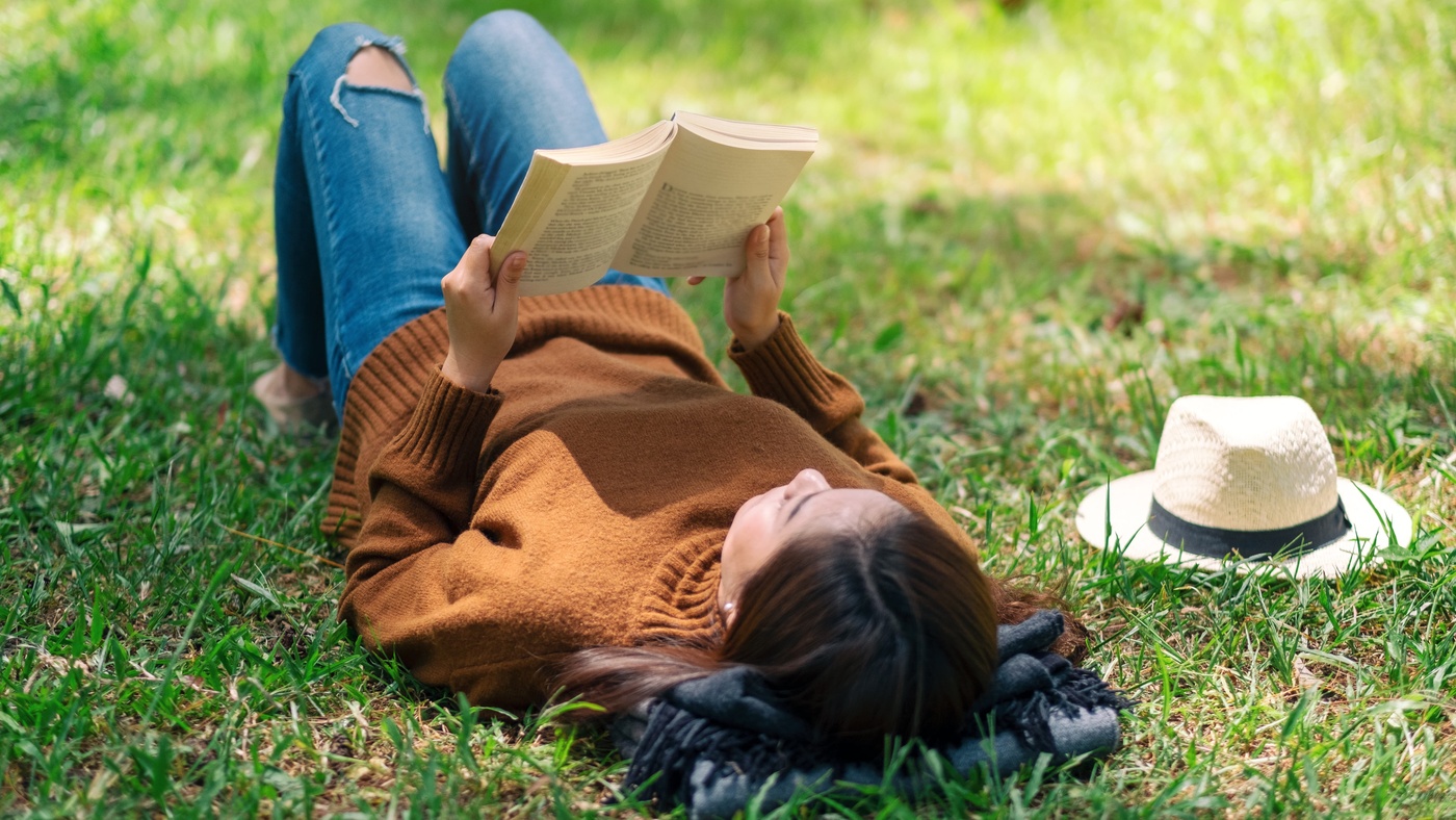 student reading book in park