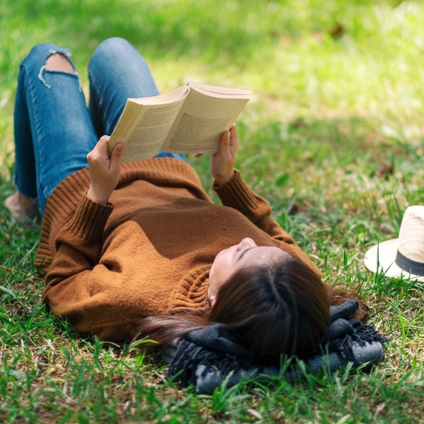 student reading book in park