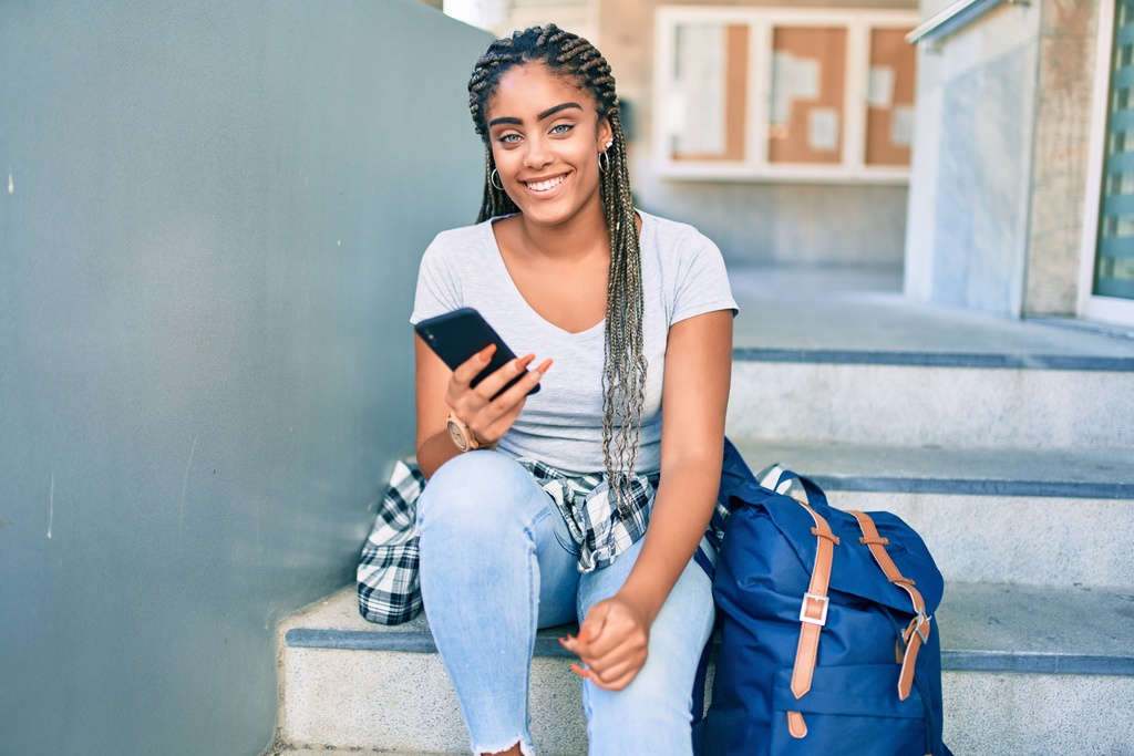 student on mobile phone outside student accommodation