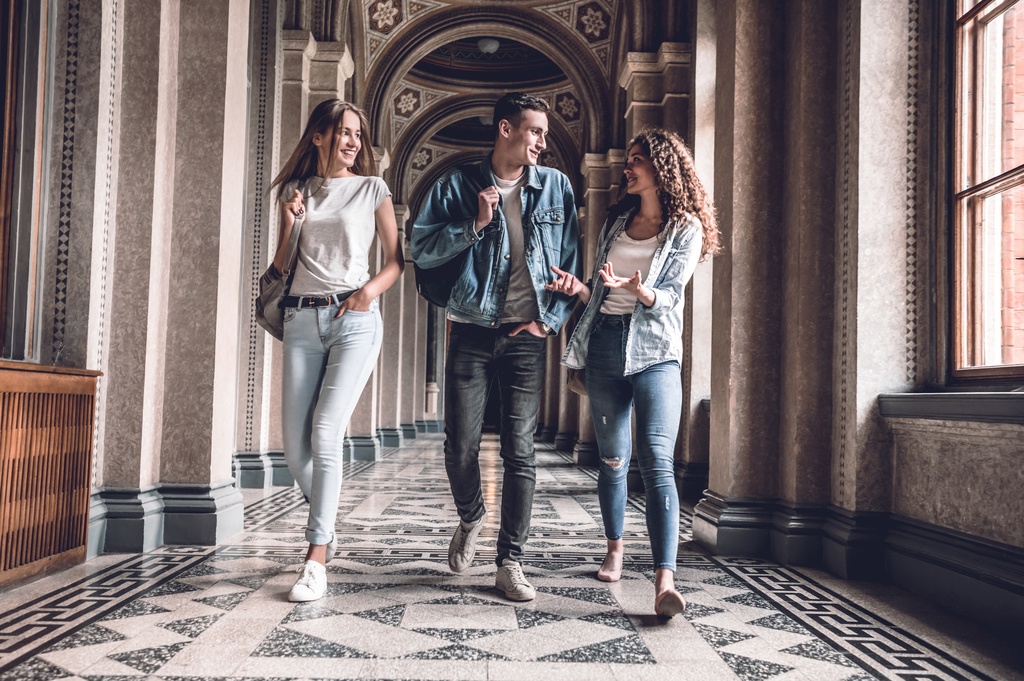students talking in university building hallway