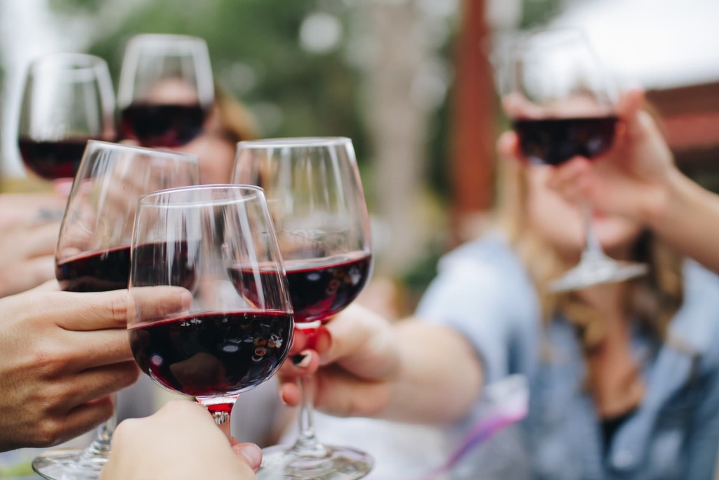 red wine glasses raising a toast