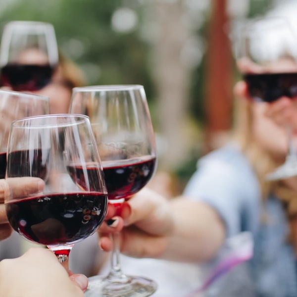 red wine glasses raising a toast