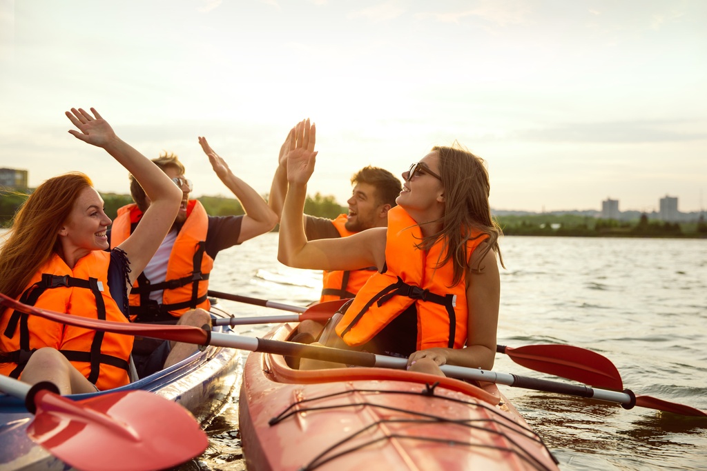 students high five canoeing