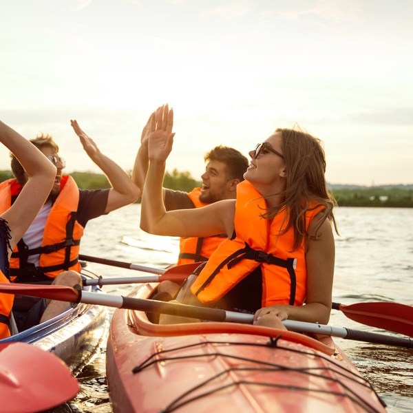 students high five canoeing