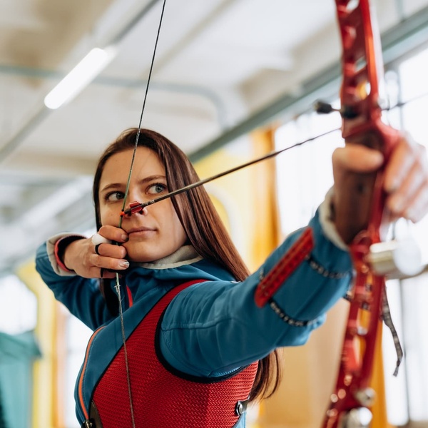 girl practising archery in student sports class