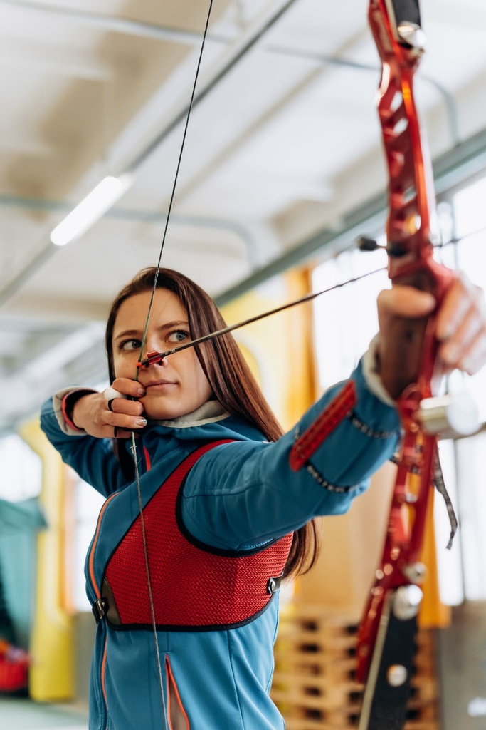 girl practising archery in student sports class