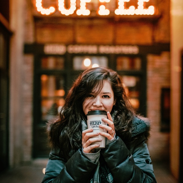 student female drinking coffee on campus