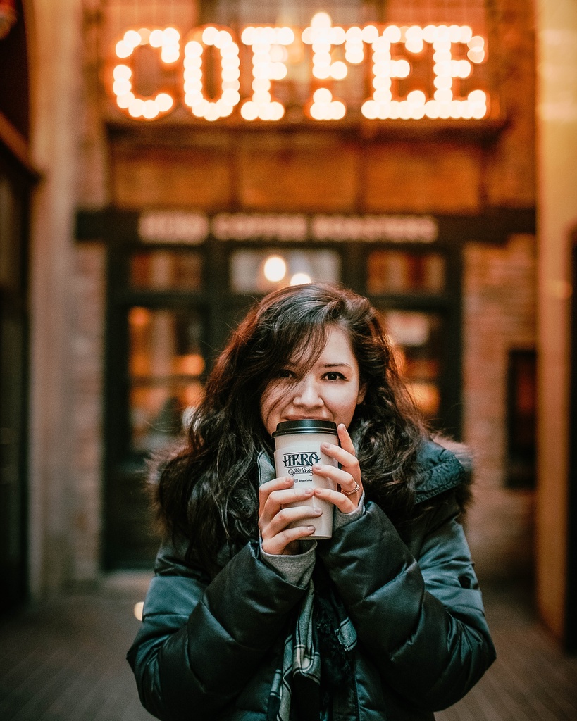 student female drinking coffee on campus