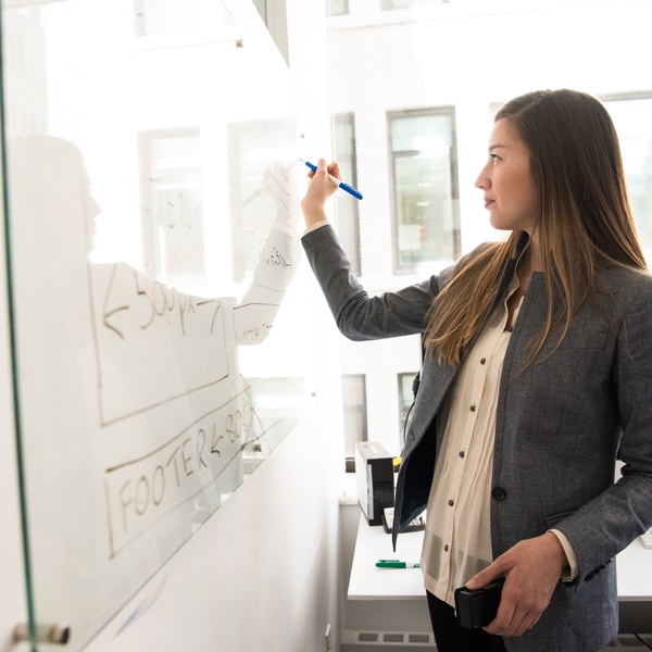 Girl writing on a white board