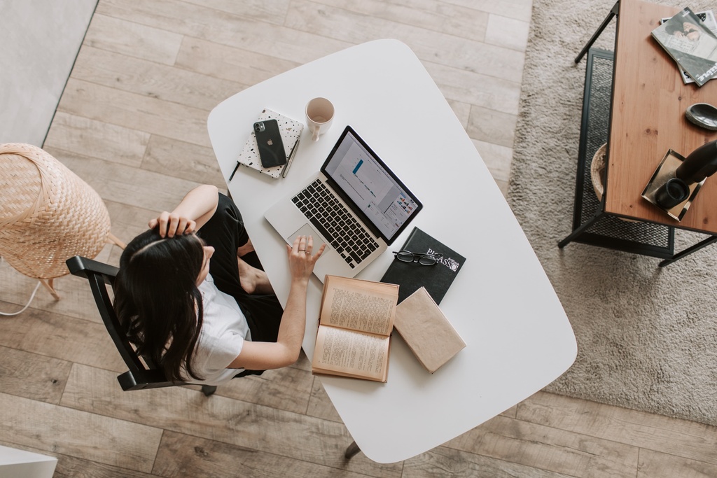 Student with laptop and books sitting at the desk