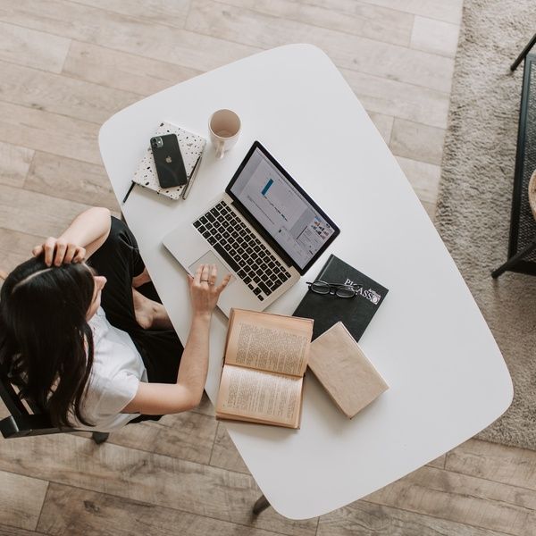 Student with laptop and books sitting at the desk