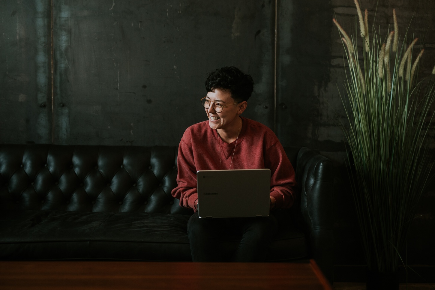 student on laptop sat on sofa