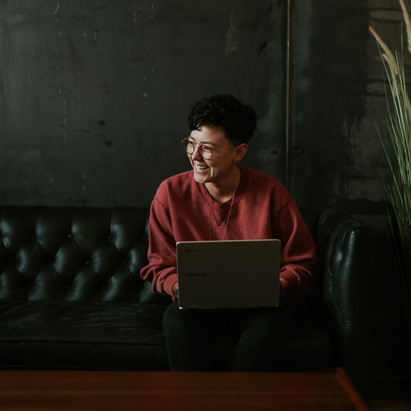 student on laptop sat on sofa