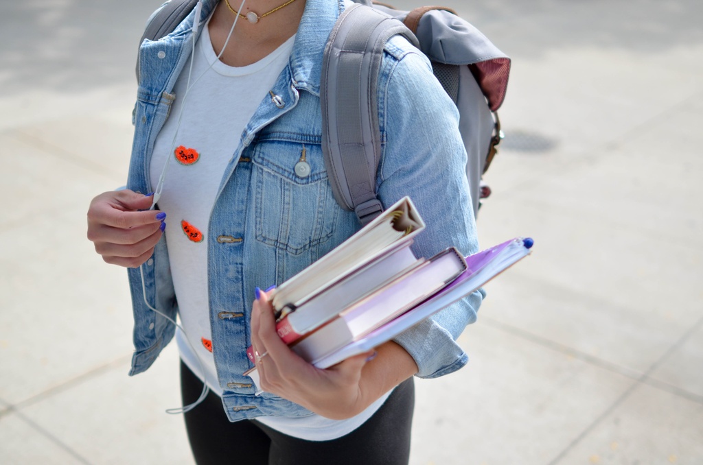 student carries books gloucester university