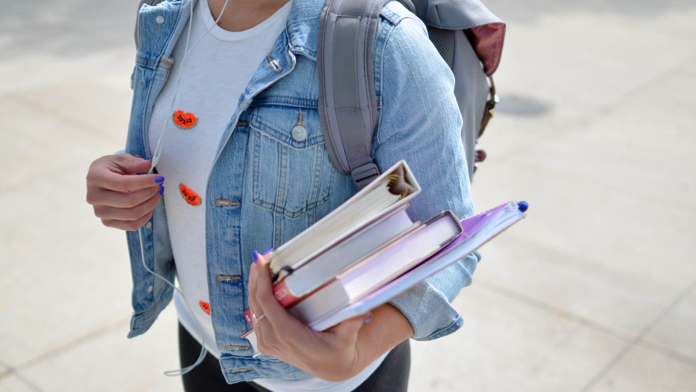 student carries books gloucester university