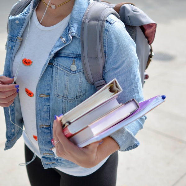 student carries books gloucester university