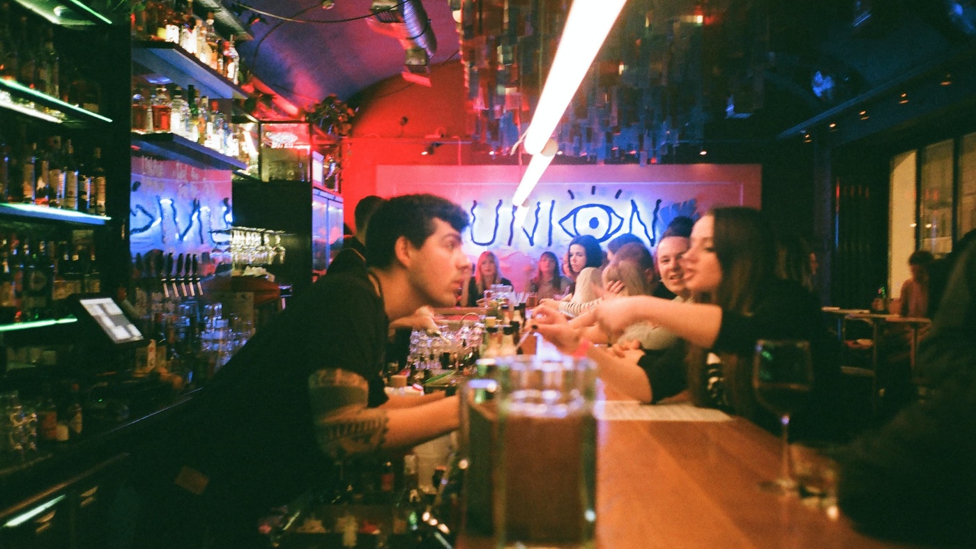 Girl ordering at the bar in a night club