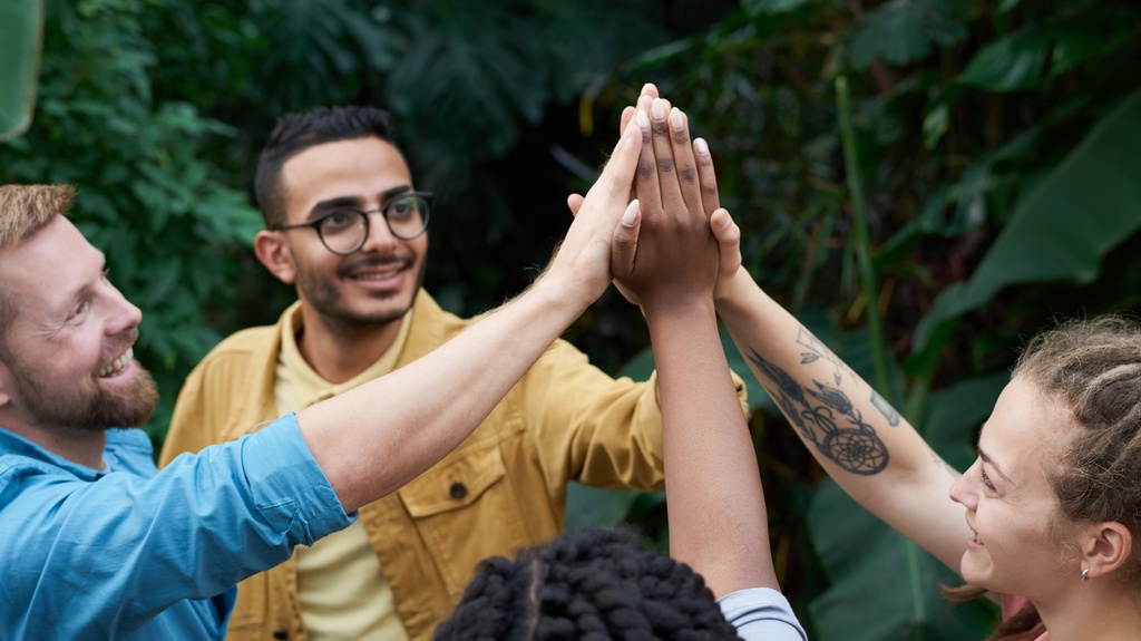 Three people high-five