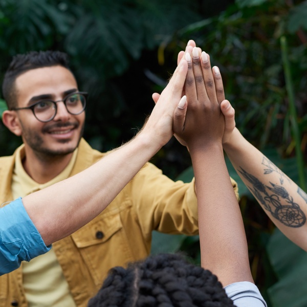Three people high-five