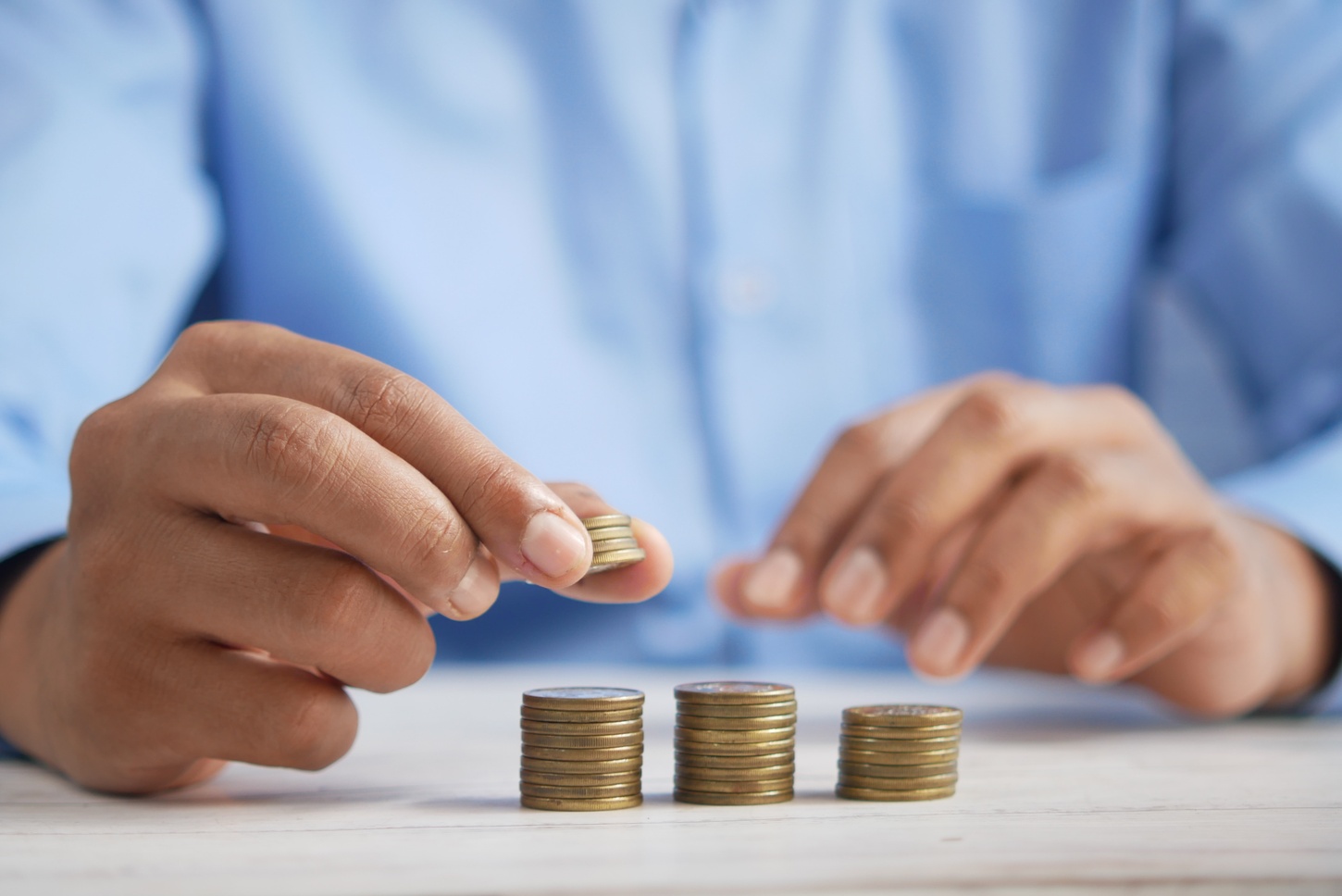 person stacking coins