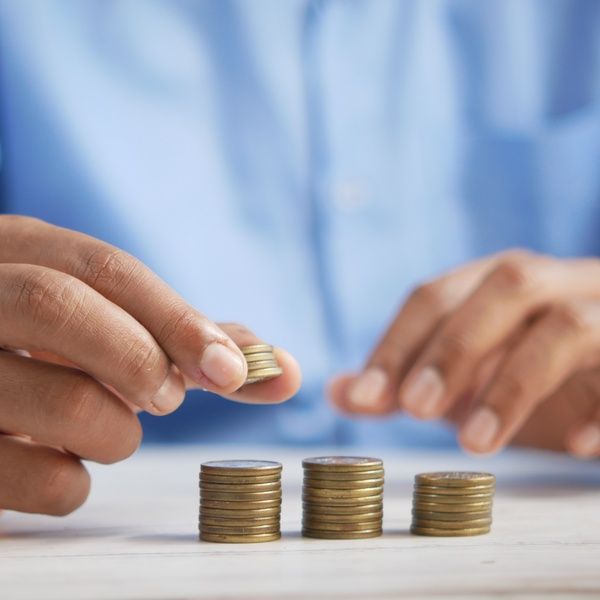 person stacking coins