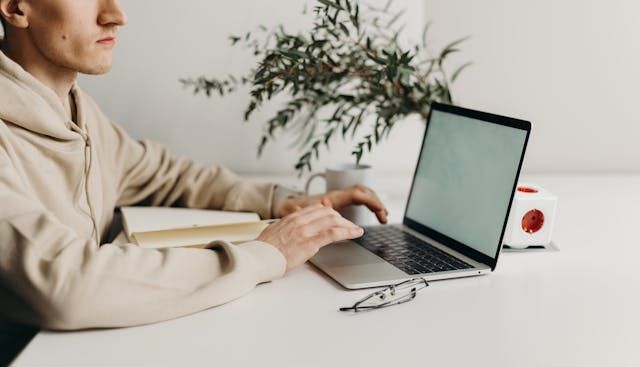 arms and hands using a laptop