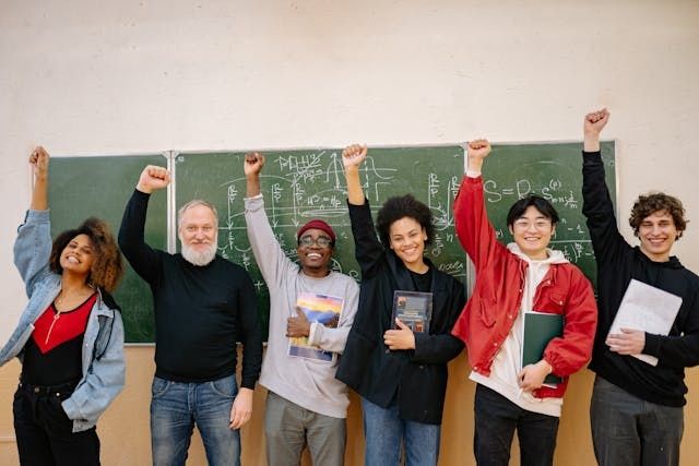 group of students and teachers cheering